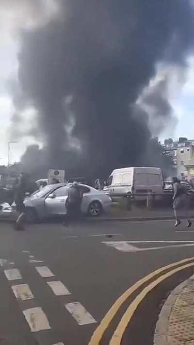 Rioters in Hull, UK destroy a man's car and drag him from it.