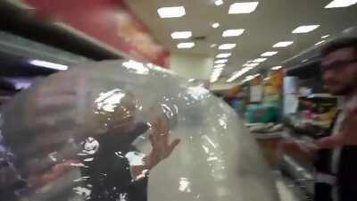Woman 'self-isolating' in ZORB BALL leaves shoppers bemused as she rolls around supermarket