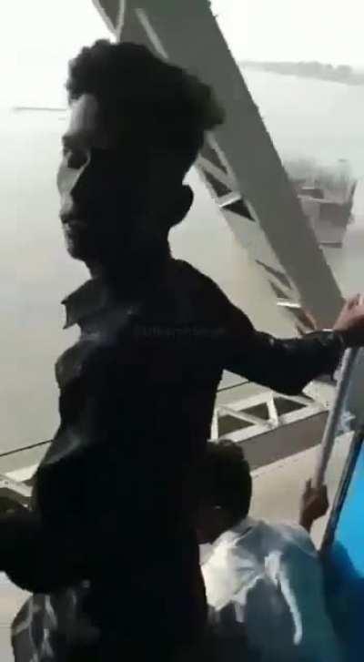 Theif hanging from Railway Bridge steals Phone from moving Train