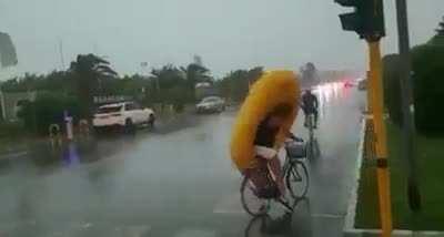 Riding a bike in the middle of a storm.