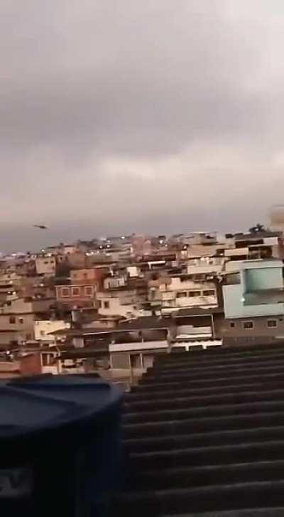 Brazil, Complexo do Alemão, a favela in Rio de Janeiro, heavily armed criminal shoots at a police helicopter