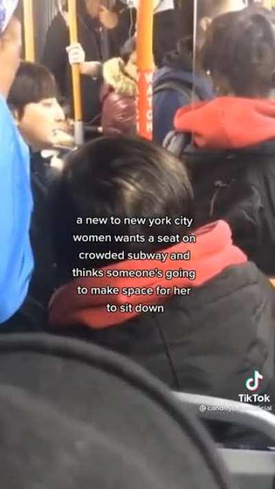 Woman demands seat on a packed train