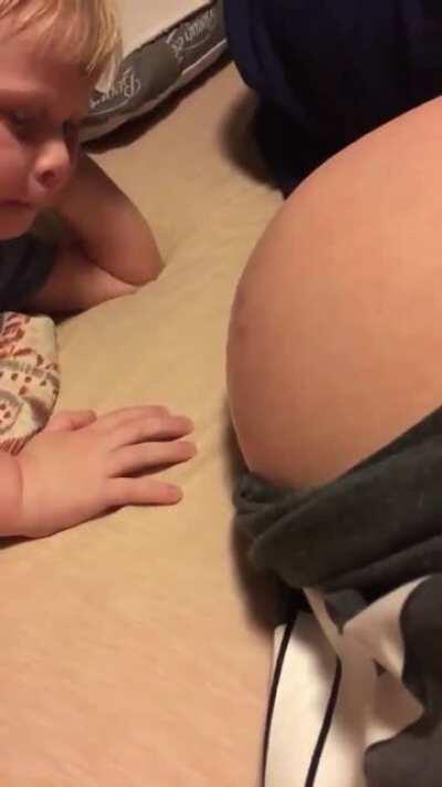 Saying hi to his sibling