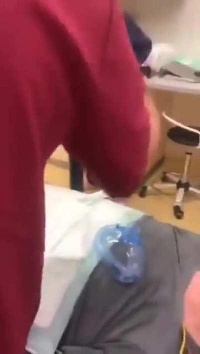 Doctors removing a cock ring