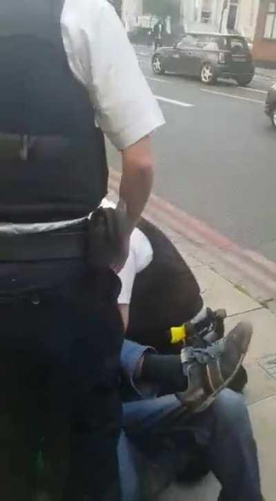 Metropolitan Police Officer Kneeling on a Black Man's Neck