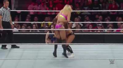 Nikki Bella hitting a Spinebuster on Charlotte