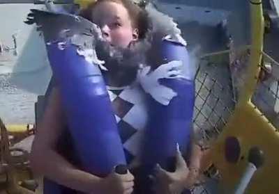 Drone strike at an amusement park leaves woman shaken and clinging to life