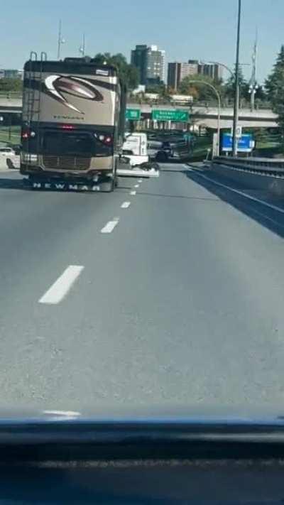 RV driver with his luggage door hanging out