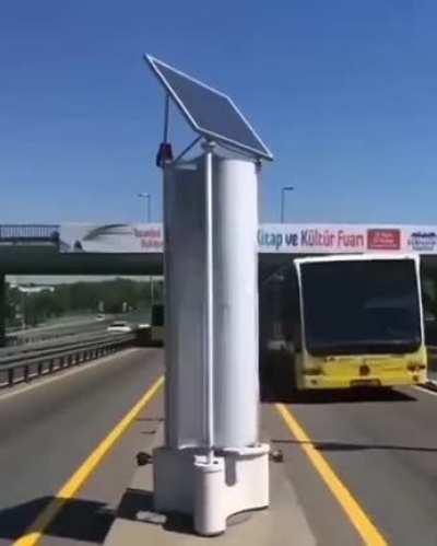 This rotating set-up harnesses wind energy from the vehicles passing by it.