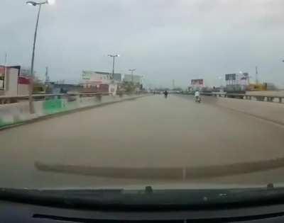 Idiot on a bike learns the hard way to not zig zag on the road