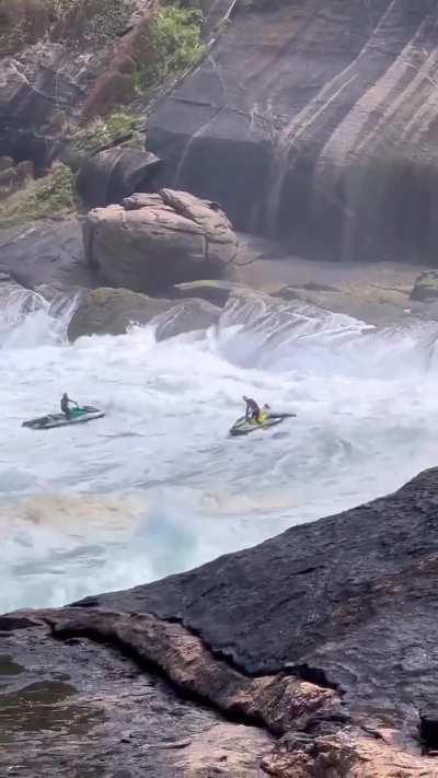 Jet ski person saves a surfer in colossal waves