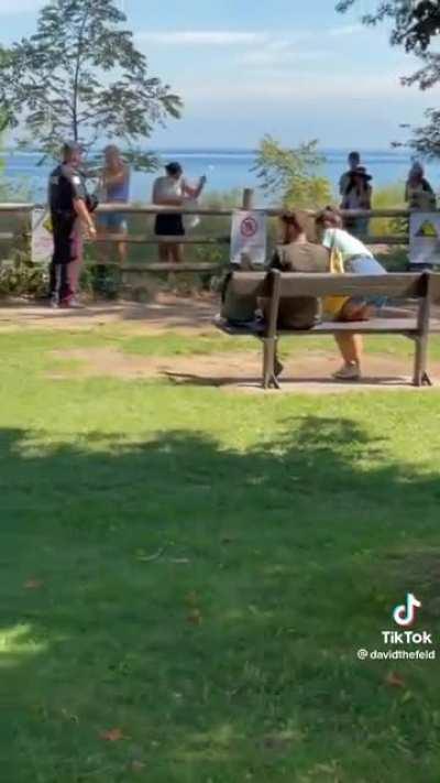 Herd of idiot tourists ignoring all danger signs and standing on crumbling cliffs, are told to line up to receive their $5,000 tickets (watch with sound)