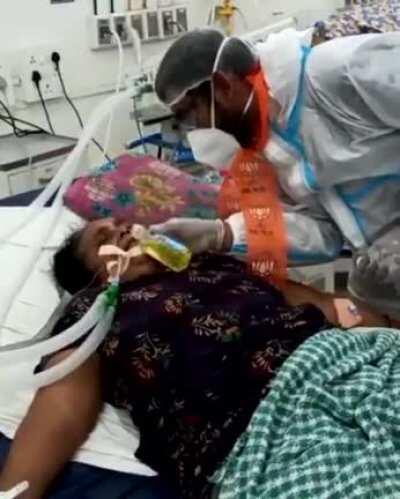 BJP politician feeding gaumutra to a covid patient on a ventilator