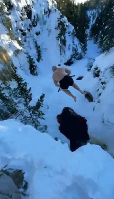 Man does a battlecry and jumps into a freezing lake with axes drawn