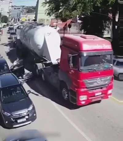 Scooter rider knocked under a truck