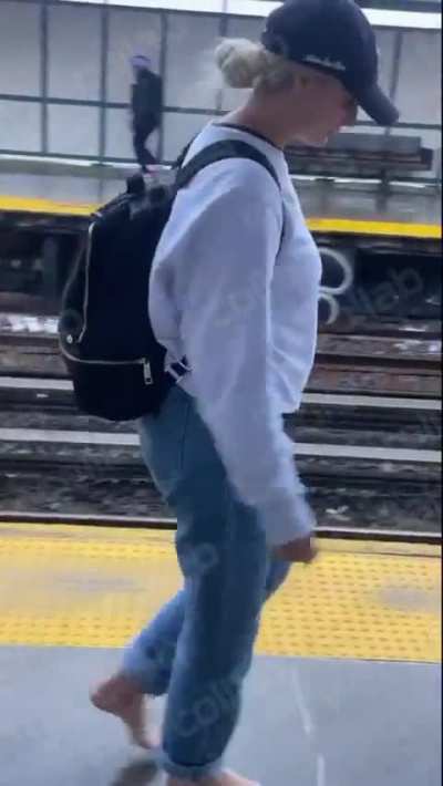 Woman walk barefoot on train station platform