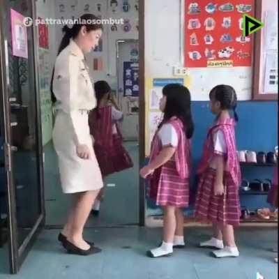 Schoolchildren in Thailand choose how they want to greet their teacher.