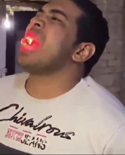 Guy eats burning coal