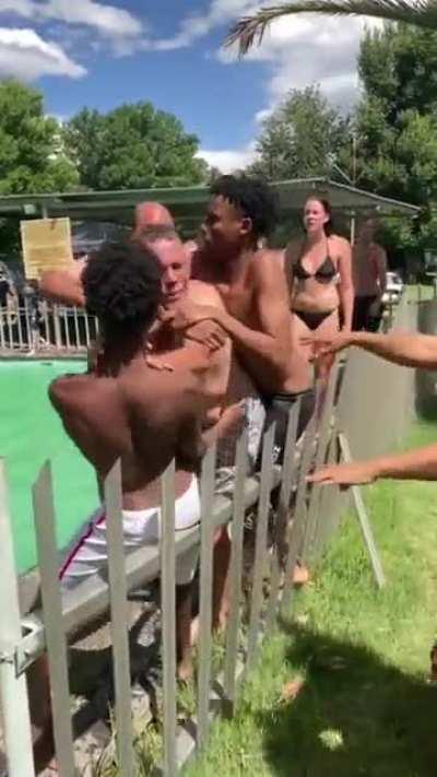 Racist old white man fighting with black kids because they are apparently not allowed in the pool as it's reserved for the 