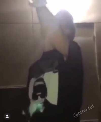 Throwing a bottle on the wall.