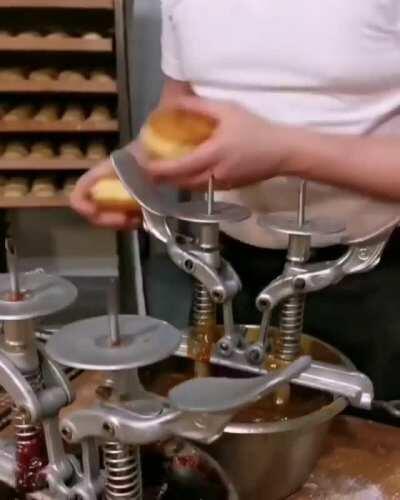 Filling donuts like its his job. Wait...it is.