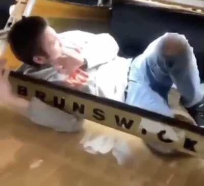 Idiot messing with the bowling ball machine