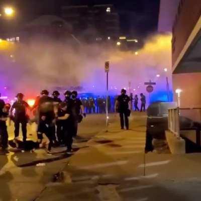 Fellow protesters try to help someone that had been pepper sprayed-- they got sprayed for that.