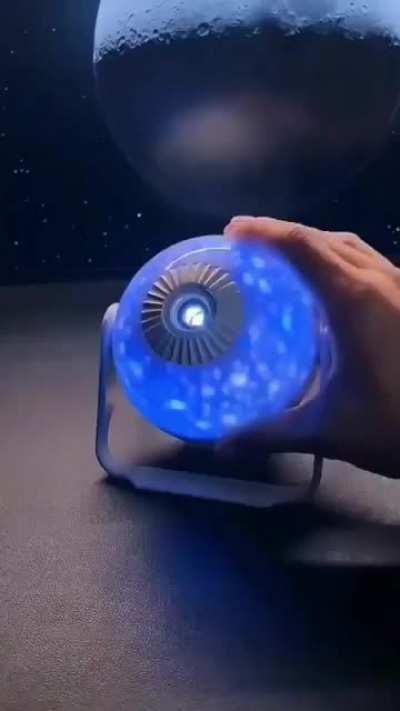 This miniature 'Galaxy Projector' casts large-scale images of galaxies onto your walls & ceilings.