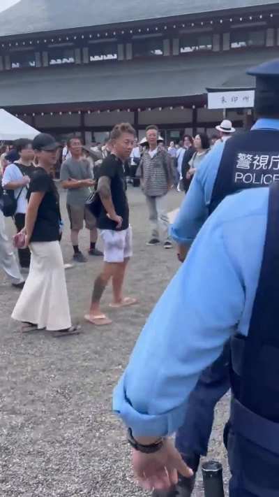 Chinese man with coolest backpack on earth protests at the infamous Yasukuni shrine in Japan. 