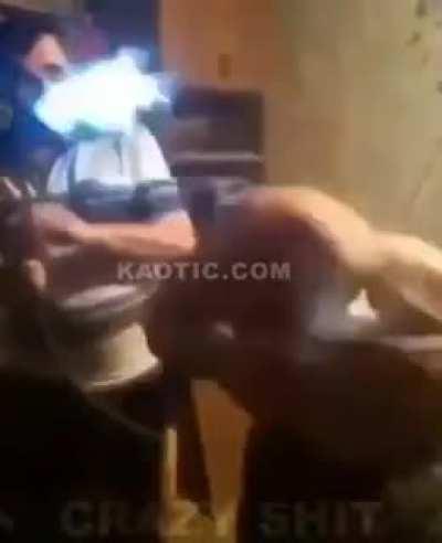 Man recieves haircut with blowtorch.