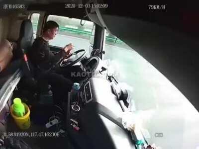 Chinese truck driver is texting while driving and ends up overturning the truck. His passenger is promptly thrown from the sleeper bed and into the dashboard.