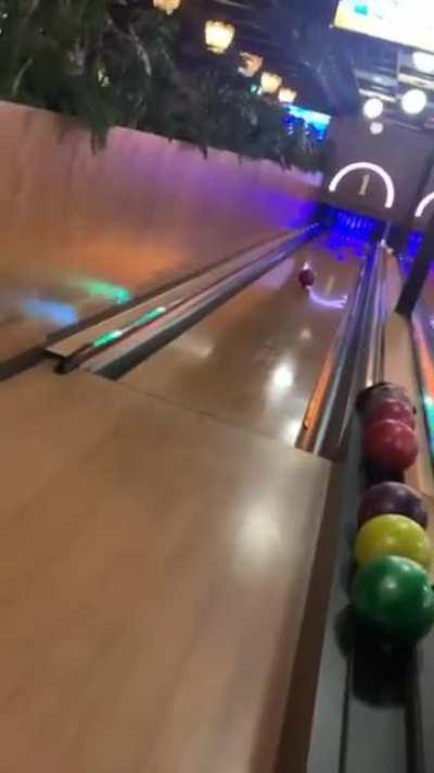 Bowling ball returns to the girl after a bad throw