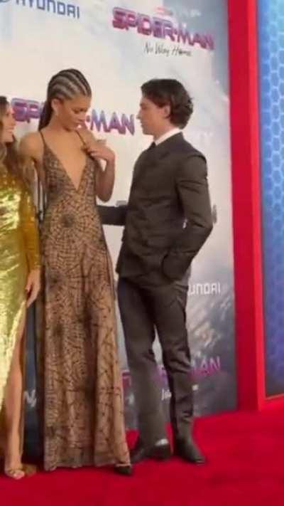 Tom Holland stepped in front Zendaya while she was fixing her dress