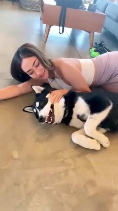 Cuddling with her dog