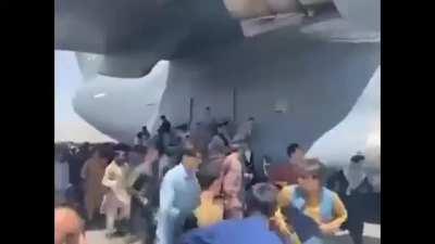 Some afghans cling to an ascending airplane while surrounding it in hopes of escaping But ultimately fall