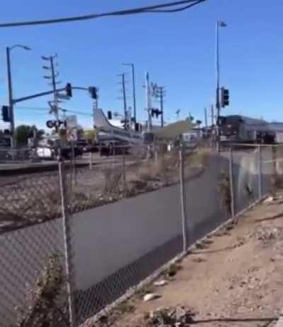 Crashed plane becomes unexpected participant in a train crash (pilot was pulled to safety just in time)