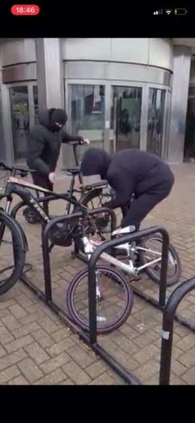 Thieves stealing a bike in broad daylight