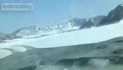 Car driving on ice goes through the ice.