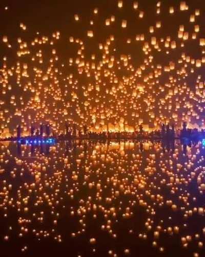 Thousands of paper lanterns launched into the night sky in Thailand.