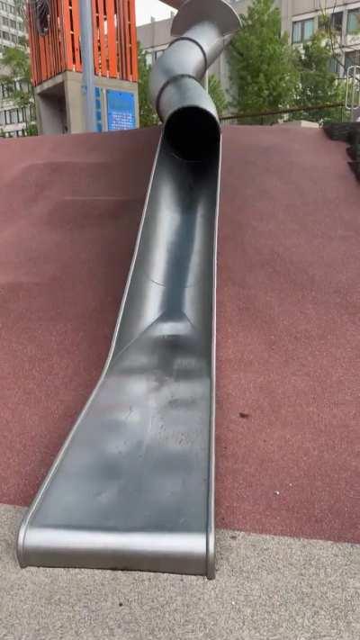 Policeman using a park slide...