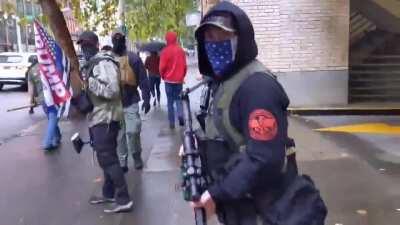 Woman filming gets threatened by some lovely Trump supporters carrying assault rifles on the sidewalk