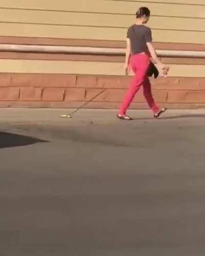 Woman takes a banana for a walk