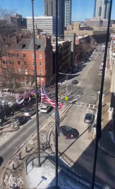 Neo Nazis marching towards government center in Boston, followed by a counter protestor chanting 