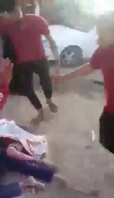 A Palestinian man runs into a group of people freaking out... then he sees the blown skulls of dead children in what appears to be headshots execution.
