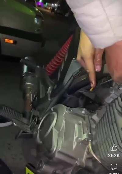 Using a motorcycle to light his cigarette