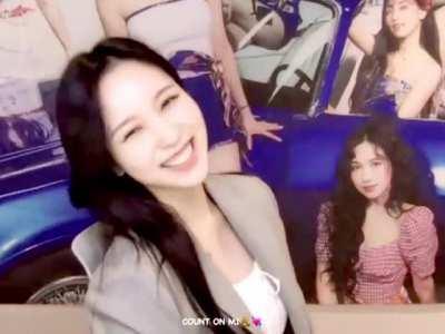 Mina - beige suit jacket, white top, lip bite