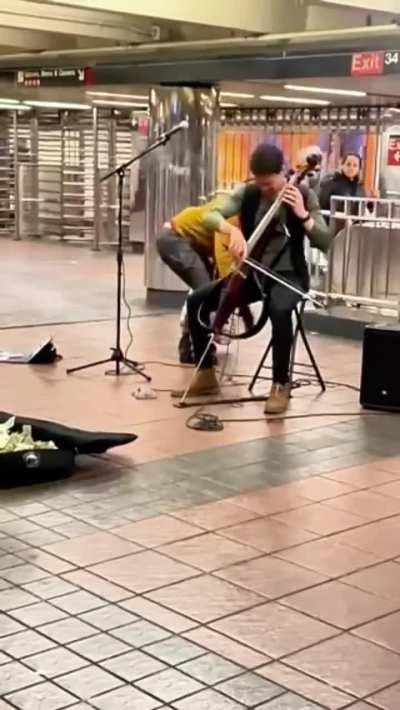 Subway musician attacked while performing.