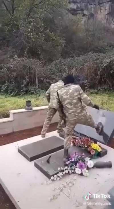 Azerbaijani soldiers vandalising armenian graves