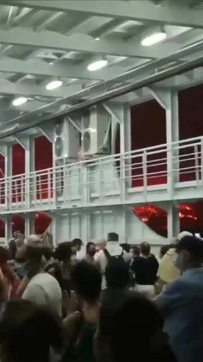 Citizens escape above a commercial ship as the huge fires , that have blocked all roads, close on them. Video taken from Evia Greece.