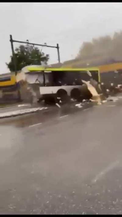 Dutch bus ripped in half by train